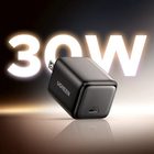 A black UGREEN 30W wall charger with a USB-C port, shown at an angle with a glowing '30W' text overlay in the background.
