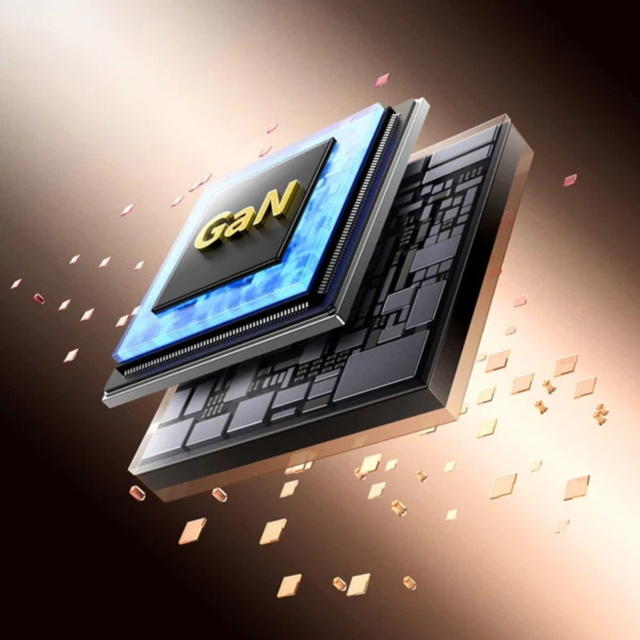 A 3D digital render of a GaN (Gallium Nitride) power chip module, featuring a glowing blue top layer and a dark gray substrate with gold accents, set against a dark brown background with floating gold particles.