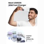 Promotional graphic for a UGREEN 30W fast charger, featuring a smiling man holding a gray USB-C charger plug against a light gray background, with several colorful charger and cable products displayed below and text reading 'Meet UGREEN 30W Fast Charger' and 'Colorful series Brilliant life'.
