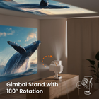 Projector displaying a whale image with a gimbal stand on a table.