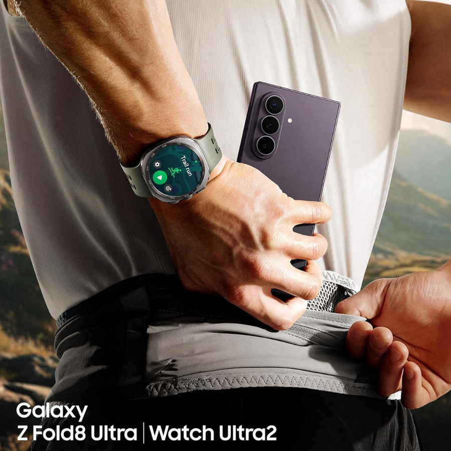 A close-up lifestyle shot of a person wearing a Samsung Galaxy Z Fold8 Ultra smartphone and a Samsung Watch Ultra2. The person is shown from the chest down, wearing a white tank top and black shorts, with the phone tucked into their waistband.