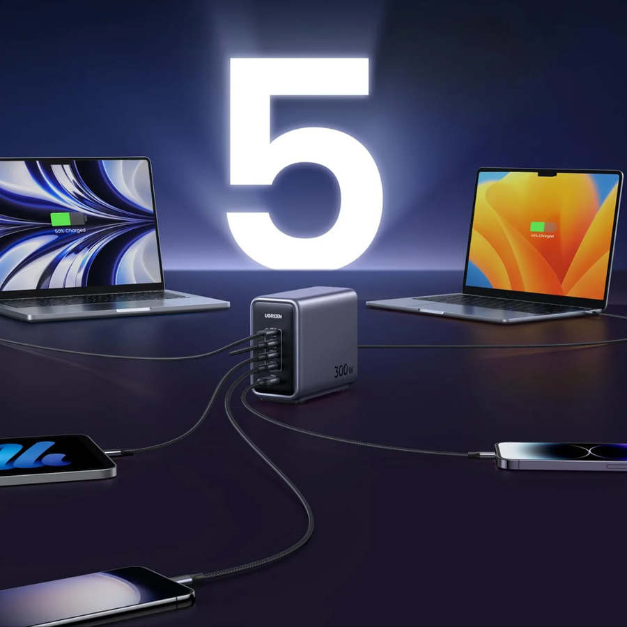 A 3-in-1 USB-C multiport charger in dark gray, shown connecting to multiple devices including two laptops, a smartphone, and a tablet. A large glowing white number '5' is displayed in the background against a dark blue gradient backdrop.