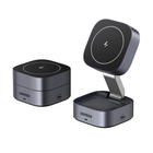 Two UGREEN wireless charging devices in a dark gray metallic finish, shown on a plain white background. One is a compact cube with a flat top, and the other is a larger base with a square charging pad and an angled arm holding a matching charging head.