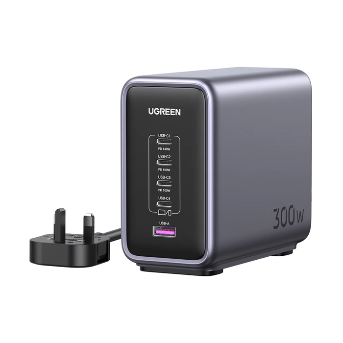 UGREEN 300W dual USB-C power bank in dark gray with a black front panel showing port details, accompanied by a black UK three-pin power adapter on a white background.