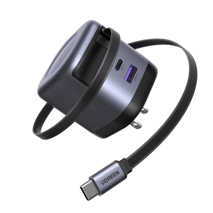 UGREEN magnetic USB-C hub and cable adapter on a solid white background. The device features a dark gray and black body with a built-in carrying loop, a USB-C port, and a USB-A port, connected to a flexible braided cable with a USB-C connector.