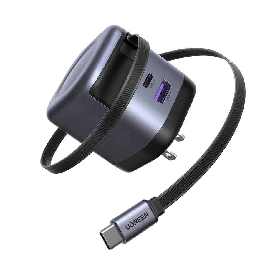 UGREEN magnetic USB-C hub and cable adapter on a solid white background. The device features a dark gray and black body with a built-in carrying loop, a USB-C port, and a USB-A port, connected to a flexible braided cable with a USB-C connector.