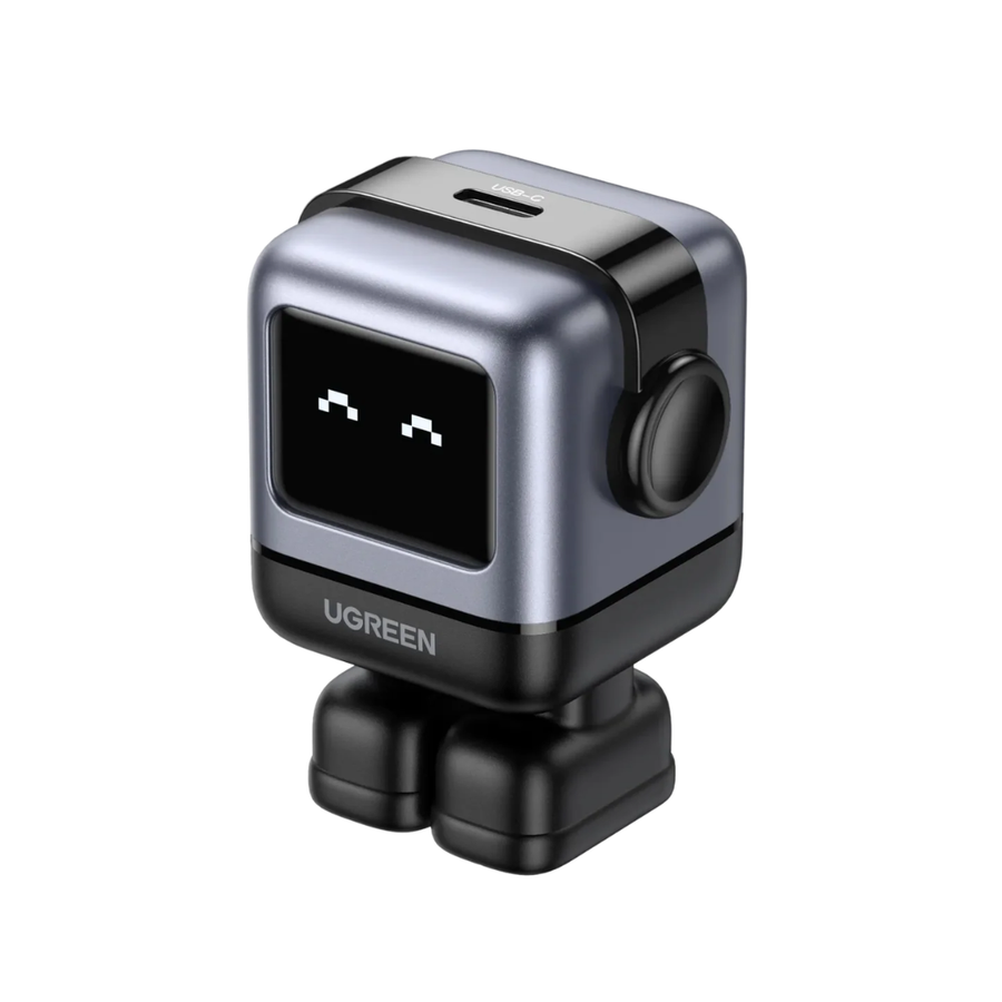 UGREEN mini robot action camera with a silver and black metallic body, a small pixel display showing a face, and a round side button, isolated on a white background.