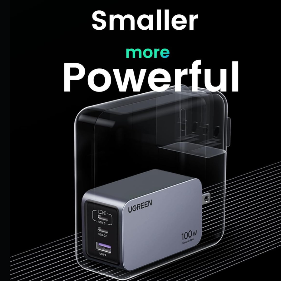 UGREEN 100W portable power bank in a sleek silver-gray finish with a black USB-C port panel, shown inside a transparent protective case on a black background with promotional text reading 'Smaller more Powerful'.
